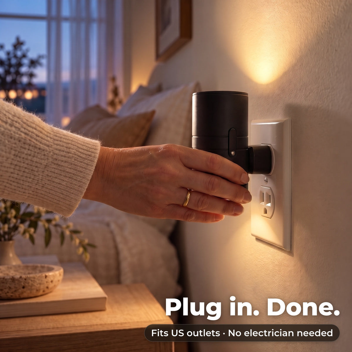 Hand plugging the wall light into a socket next to the bed
